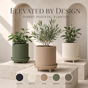 May include: Three cylindrical ribbed pedestal planters in olive green, oak, and white, each with a matching saucer and small feet. The text reads Elevated by Design and Ribbed Pedestal Planter, with colour swatches for black, white, oak, green, and brown.