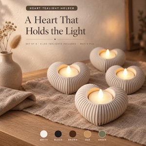 May include: A set of four off-white heart-shaped tealight holders with a ribbed texture. Each holder contains a glowing LED tealight. The text reads: Heart Tealight Holder, A Heart That Holds the Light, Set of 4 - 4 LED tealights included - matte PLA.