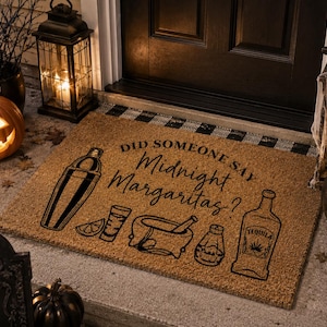 May include: A rectangular tan coir doormat featuring black printed graphics of a cocktail shaker, a lime wedge, a shot glass, a mortar and pestle, a salt shaker, and a tequila bottle with the text DID SOMEONE SAY Midnight Margaritas?