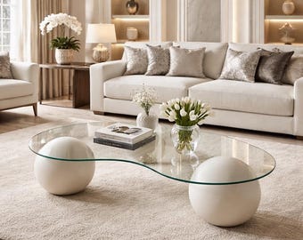 Modernt ovalt soffbord i glas med skulpturala sfärben, minimalistiskt vardagsrumsbord, lyxig mittbordsdekor