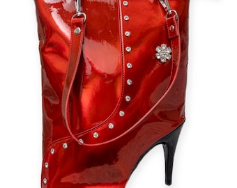 Red high heel designer handbag with internal zip pockets, handles and can stand alone.