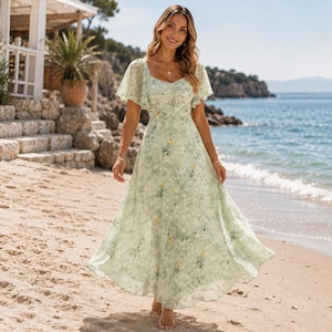 May include: A floor-length light green dress featuring a delicate floral pattern, short flutter sleeves, a ruched bodice, and a square neckline. The garment has a flowing, A-line skirt that reaches the ankles, crafted from a lightweight fabric.