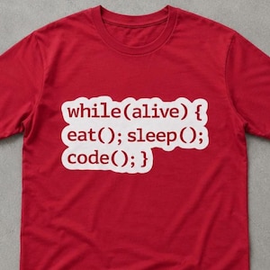 May include: A bright red short-sleeved t-shirt featuring a white graphic patch on the chest. The text printed in red on the white patch reads: while(alive) { eat(); sleep(); code(); } in a programming syntax style with a rounded rectangular shape.