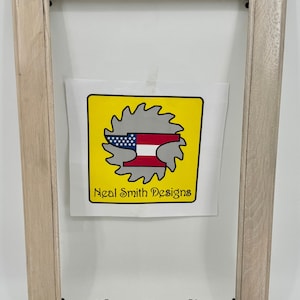 May include: A light wood picture frame with a clear acrylic insert. The frame has a simple design and is ready to display your favorite photos or artwork. The text "Clear Acrylic" is printed below the frame.