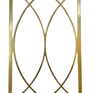 May include: A rectangular gold-coloured metal wall decor piece featuring a symmetrical openwork design. The frame contains two intersecting curved arches that create a pointed oval shape in the centre, set within a clean, straight-edged border.