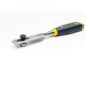 May include: A woodworking chisel with a black and yellow handle and a silver blade. The blade has a small adjustable guide attached. The chisel is designed for precision work and is set against a white background.