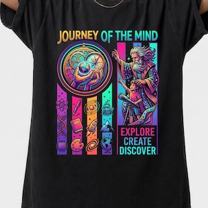 May include: Black t-shirt with a colorful graphic. The design features the text "JOURNEY OF THE MIND" above an illustration of a wizard and a child with a telescope. Below the illustration are the words "EXPLORE CREATE DISCOVER".