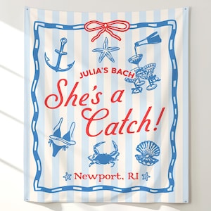 May include: A rectangular wall tapestry with light blue and white vertical stripes. It features a red bow, blue nautical illustrations of an anchor, starfish, crab, seashell, bikini, and champagne glasses, with the text "Julia's Bach She's a Catch! Newport, RI".