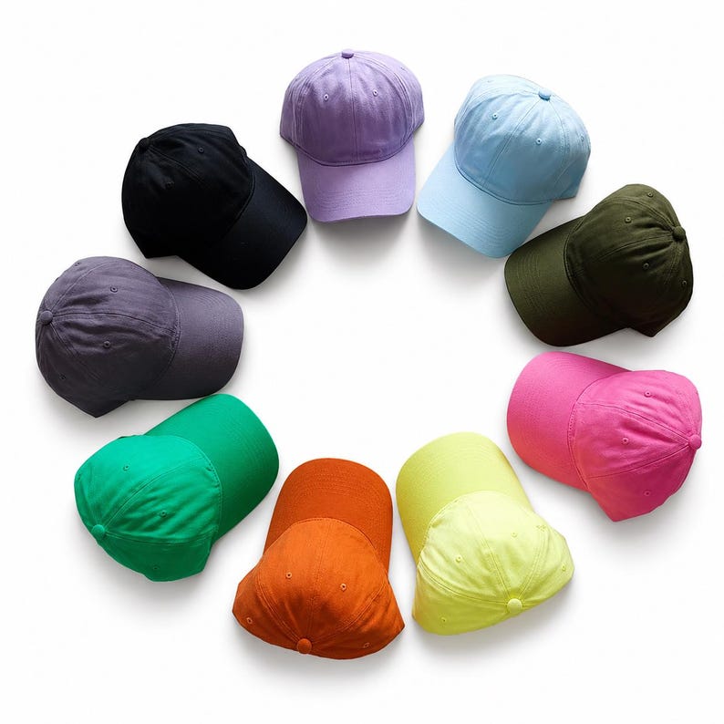 May include: A collection of ten baseball caps in various colors, including black, purple, light blue, olive green, pink, yellow, orange, and green. The caps are arranged in a circular pattern against a white background.