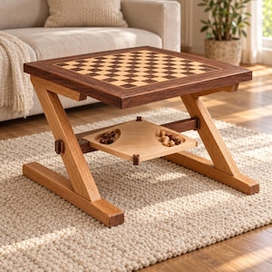 May include: A wooden coffee table featuring a built-in chessboard top with alternating light and dark squares. The table has a Z-shaped frame and a lower shelf with two recessed compartments containing small wooden chess pieces in two colors.