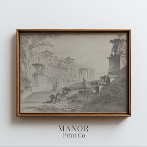 Op de afbeelding: Een ingelijste zwart-wit architecturale prent. Het kunstwerk toont een gedetailleerde tekening van een groot gebouw met trappen, beelden en figuren. De lijst is warmbruin van kleur en de prent is gelabeld "MANOR Print Co."