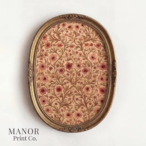 May include: An oval-shaped framed print featuring a floral pattern in shades of pink and brown. The frame is gold with ornate detailing. The text "MANOR Print Co." is at the bottom.