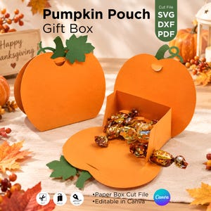 May include: Two orange pumpkin-shaped paper gift boxes with green paper leaves and stems. One box is closed, and the other is open, revealing gold-wrapped candies inside. Text on the image reads Pumpkin Pouch Gift Box, SVG, DXF, PDF, Paper Box Cut File, and Editable in Canva.