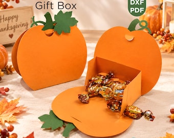 May include: Two orange pumpkin-shaped paper gift boxes with green paper leaves and stems. One box is closed, and the other is open, revealing gold-wrapped candies inside. Text on the image reads Pumpkin Pouch Gift Box, SVG, DXF, PDF, Paper Box Cut File, and Editable in Canva.