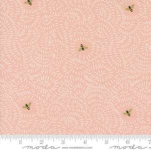 May include: Pink fabric with a white swirl pattern and gold bees. The fabric has a ruler with inches marked on it. The text "moda" is printed on the ruler.