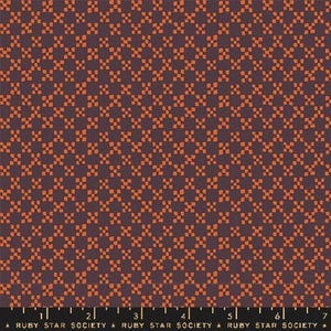 May include: A fabric with a repeating pattern of orange squares on a dark purple background. The fabric has a grid-like design, with the orange squares arranged in a diagonal pattern. The text "RUBY STAR SOCIETY" is at the bottom.