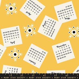 May include: A yellow fabric featuring a repeating pattern of calendar pages and floral designs. The calendar pages show months such as April, May, July, August, October, and November. The floral designs are white with black centres.