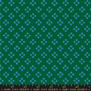 May include: Green fabric with a repeating pattern of blue dot clusters. The dots are arranged in a grid-like fashion, creating a visually appealing and symmetrical design. The fabric has a smooth texture and is suitable for various sewing projects.
