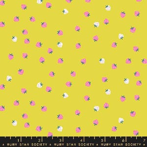 May include: A fabric with a bright yellow background, covered in a pattern of pink and white strawberries with green stems. The fabric has a ruler along the bottom with the text "RUBY STAR SOCIETY".
