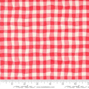 May include: Red and white gingham fabric with a wavy pattern. The fabric has a classic checkered design, with the red squares slightly irregular in shape. A ruler is at the bottom of the image, showing measurements in inches.
