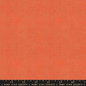 May include: A solid coral orange fabric with a subtle texture. The fabric is a plain weave with a slightly rough feel.