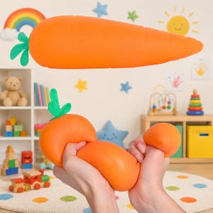 May include: An orange carrot-shaped toy with green leafy tops. The toy is being squeezed by a person's hands. The background includes a rainbow, a sun, and other toys.