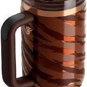K&ouml;nnte beinhalten: Ein brauner isolierter Becher mit Henkel und Strohhalm. Der Becher hat ein Tigerstreifenmuster in Braun- und Goldt&ouml;nen. Der Griff ist dunkelbraun mit einem schwarzen Griff. Der Deckel ist braun und hat einen Schiebeverschluss.