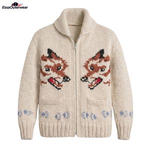 May include: A cream-coloured knit cardigan featuring a full-length front zip and a shawl collar. The front displays two symmetrical fox head graphics in brown, black and red, with light blue paw print patterns along the bottom hem and cuffs.
