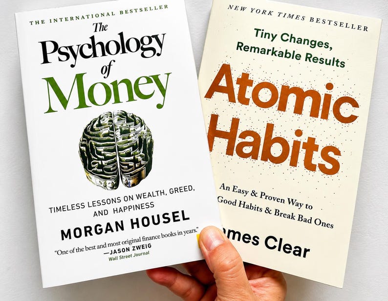 May include: Two books are displayed, one titled "The Psychology of Money" with a brain graphic, and the other "Atomic Habits." The first book is by Morgan Housel, and the second is by James Clear. Both are bestsellers.