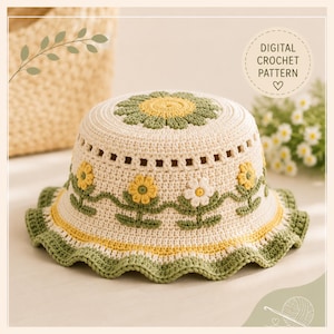 Puede incluir: Un sombrero de pescador de ganchillo color crema con un motivo de flores verdes y amarillas en la parte superior y los lados. El sombrero incluye un ala verde ondulada y una banda de hilo amarillo. El texto dice: DIGITAL CROCHET PATTERN.