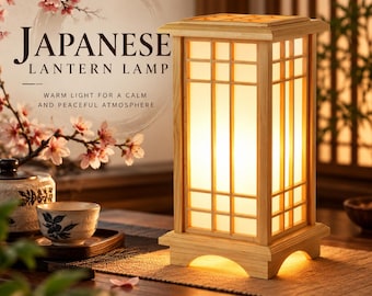 May include: A rectangular wooden lantern lamp with a grid-patterned frame and a glowing white interior. The lamp features a light-colored wood base with arched cutouts and emits a warm light. Text on the image reads: JAPANESE LANTERN LAMP.