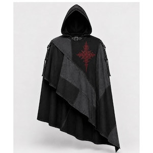 May include: Black hooded cloak with a patchwork design. The cloak features a red embroidered cross on the upper chest and a buckle closure at the neck. The cloak has a draped, asymmetrical hemline.