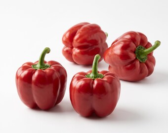 May include: Four vibrant red bell peppers with smooth, glossy skins and green stems arranged on a plain white background. The peppers are rounded and multi-lobed, displaying a uniform deep red color. The text RADENIQUE is in the corner.