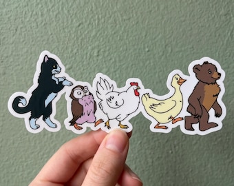 May include: A sticker featuring a line of cartoon animals: a black and white cat, a brown and purple owl, a white chicken, a yellow duck, and a brown bear. The animals are walking in a row.