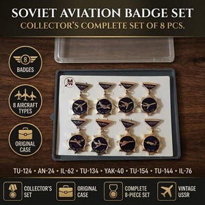 May include: A set of eight Soviet aviation badges displayed in a gray plastic case. Each badge features a gold-toned star shape with a dark blue circular center depicting a different aircraft model, including the TU-124, AN-24, IL-62, TU-134, YAK-40, TU-154, TU-144, and IL-76.