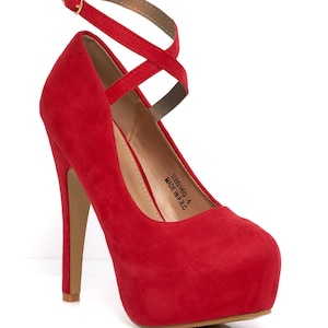 May include: Red platform high heel shoe with a crisscross ankle strap. The shoe has a rounded toe and a stiletto heel. The heel height is approximately 4 inches. The shoe is made in P.R.C.