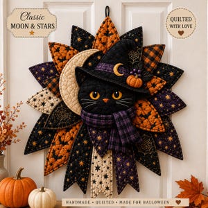May include: A quilted fabric wall hanging featuring a black cat wearing a witch hat and a purple plaid scarf. The cat is surrounded by star-shaped fabric petals in orange, black, and cream patterns with moon, star, and spiderweb motifs.