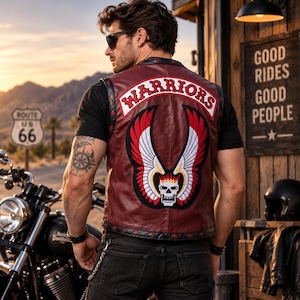May include: A maroon leather vest featuring a large embroidered patch on the back with the text WARRIORS, a skull with a crown, and red and white wings. The vest has black diamond-patterned trim along the edges and is worn over a black t-shirt.