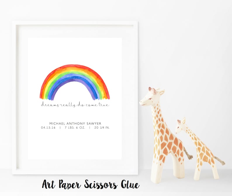 May include: A framed print with a watercolor rainbow illustration. The text "dreams really do come true" is below the rainbow. The print includes the name Michael Anthony Sawyer, birthdate, weight (7 lbs. 6 oz.), and height (20 1/4 in.).