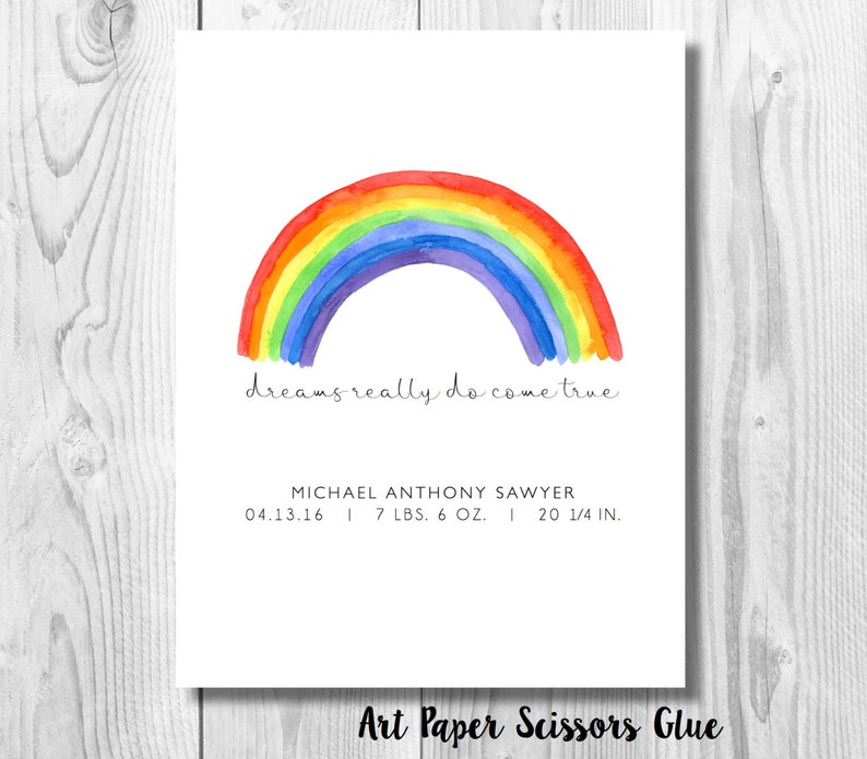 May include: A watercolor print featuring a vibrant rainbow arching over the phrase "dreams really do come true." Below, it includes the name Michael Anthony Sawyer, birthdate, weight (7 lbs 6 oz), and length (20 1/4 in).