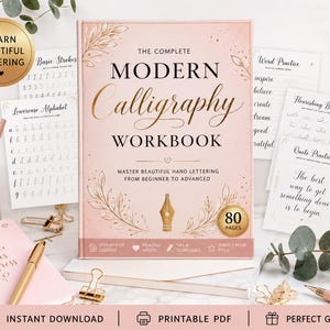 May include: A pink workbook titled The Complete Modern Calligraphy Workbook with gold lettering and leaf illustrations. The cover features a fountain pen icon and states 80 pages. Surrounding it are practice sheets, pens, and a notebook.