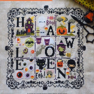 May include: A cross stitch pattern sampler featuring a Halloween theme. The pattern includes the word "Halloween" with various spooky and cute characters and objects, including a ghost, a witch, a cat, a pumpkin, and a candy corn.
