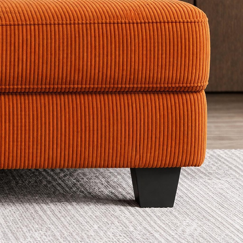 Orange sofa leg detail, black tapered legs, sturdy base modern couch, contemporary living room furniture