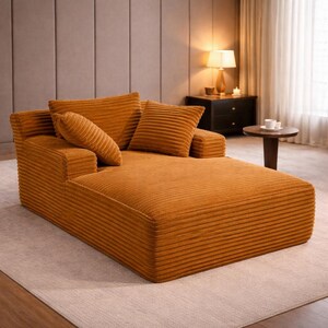 Mustard yellow corduroy chaise lounge with thick cushions and warm tone, adding a bold accent to the room.