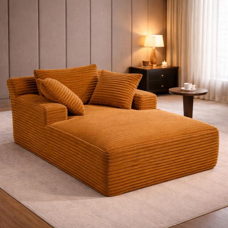 Mustard yellow corduroy chaise lounge with thick cushions and warm tone, adding a bold accent to the room.