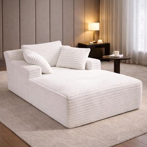 White corduroy chaise lounge with textured fabric and supportive cushions, shown in a calm neutral interior.