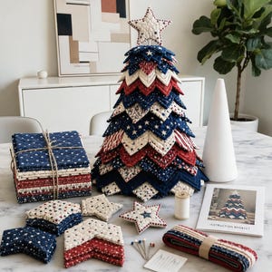 May include: A quilted fabric Christmas tree craft kit featuring red, white, and blue star-patterned fabric pieces, a star topper, a spool of thread, sewing pins, a roll of fabric trim, and an instruction booklet with a photo of the finished tree.