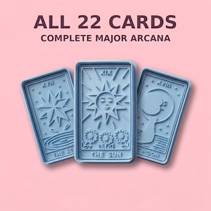 May include: Three light blue rectangular cookie cutters featuring embossed tarot card designs. The center cutter displays The Sun with Roman numeral XIX, flanked by The Star with XVII and The Moon with XVIII. Text reads ALL 22 CARDS COMPLETE MAJOR ARCANA.