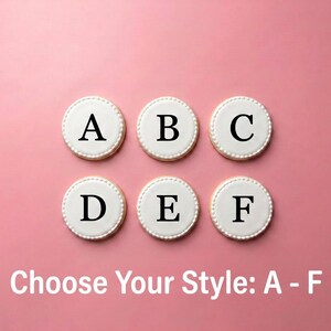 six round cookies with the letters "A", "B", "C", "D", "E", and "F" on them, arranged in a grid against a pink background.