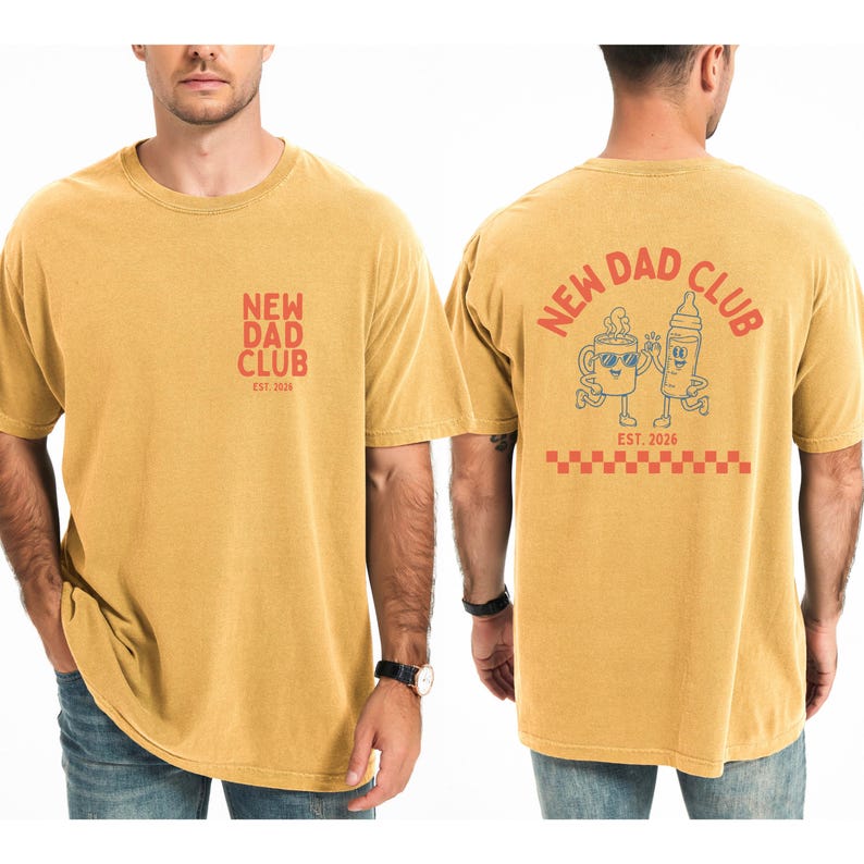May include: Mustard yellow t-shirt with "NEW DAD CLUB" printed in red on the front and back. The back features a cartoon coffee cup and baby bottle, with "EST. 2026" below. The shirt is a comfortable, casual style.